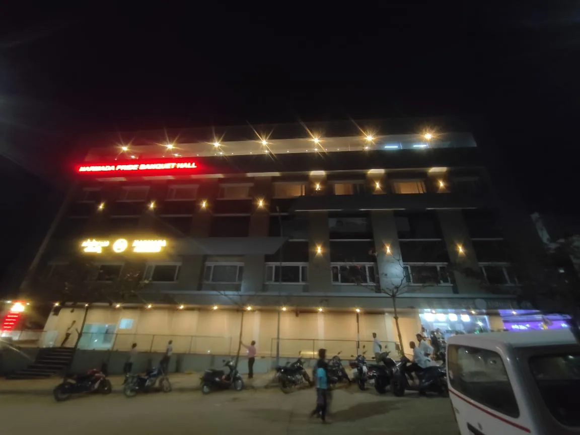 Exterior facade lighting installed on a multi-storey commercial building at night